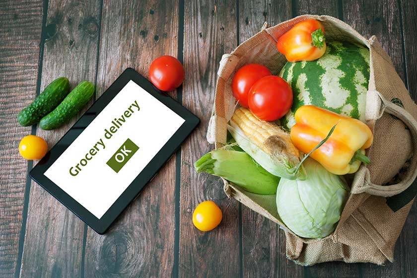 Organic Vegetables and fruits in cotton bag and tablet Organic Vegetables and fruits in cotton bag and tablet