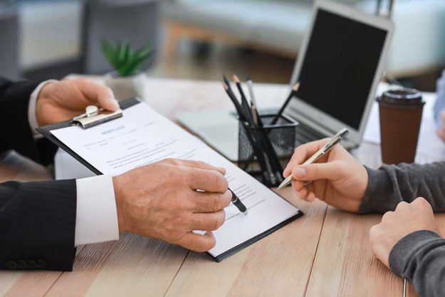 Man signing documents at notary public office