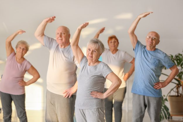 Elderly people exercising in gym Elderly people exercising in gym