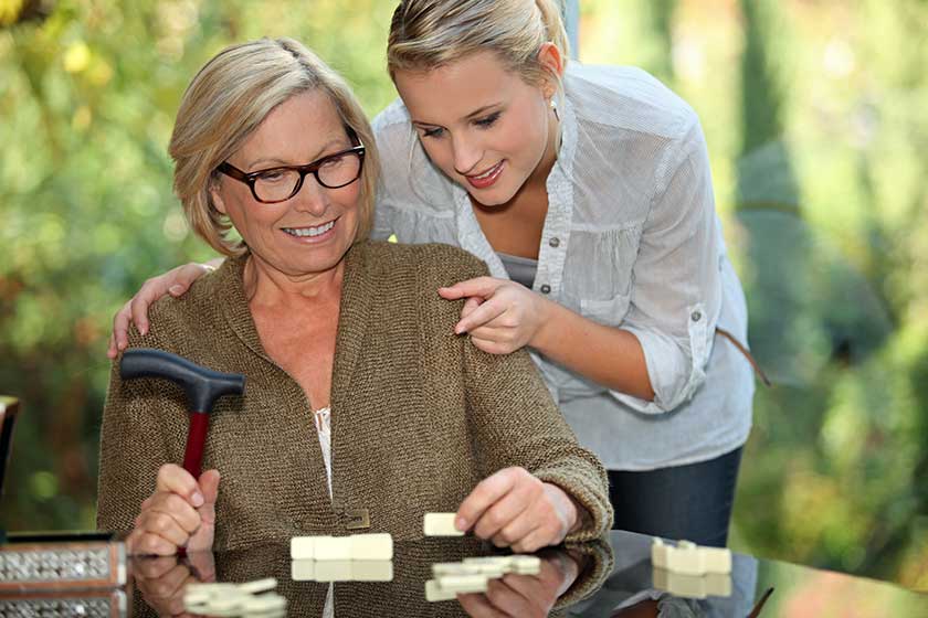 Grandmother and granddaughter playing dominoes Grandmother and granddaughter playing dominoes