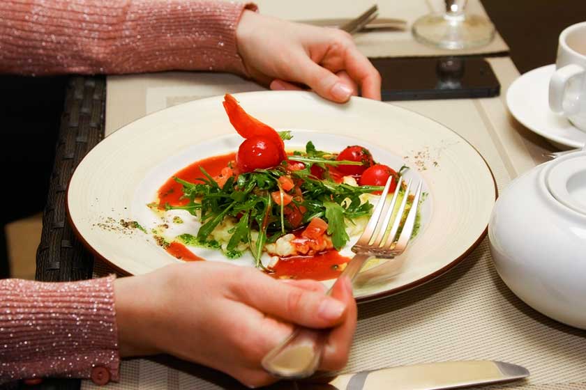 women eating tomato in variety vegetables in salad plate during diet women eating tomato in variety vegetables in salad plate during diet