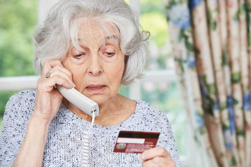 Senior Woman Giving Credit Card Details On The Phone Senior Woman Giving Credit Card Details On The Phone