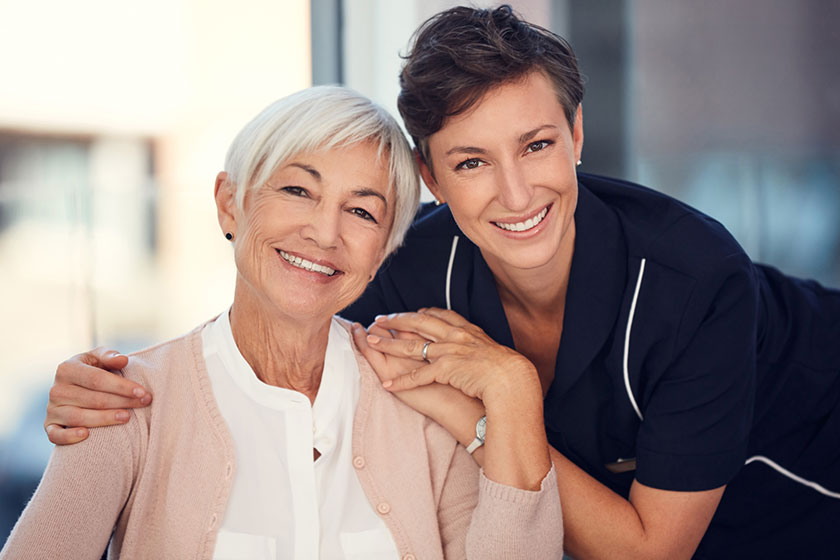 Cropped portrait of a young female nurse embracing a senior woman sitting in a wheelchair Cropped portrait of a young female nurse embracing a senior woman sitting in a wheelchair