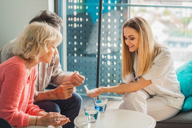 Woman Caregiver Helping Senior Married Couple Woman Caregiver Helping Senior Married Couple