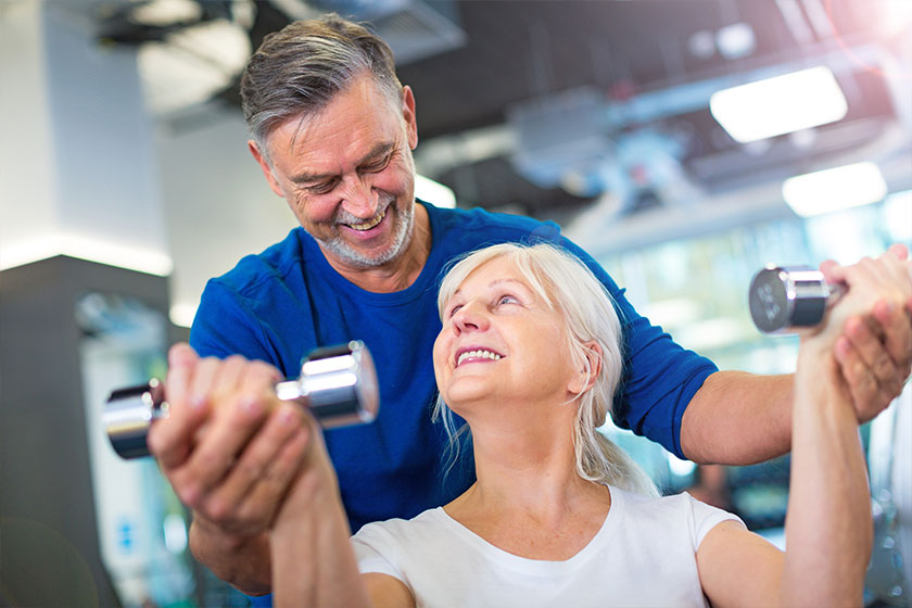 Senior couple exercising in gym Senior couple exercising in gym