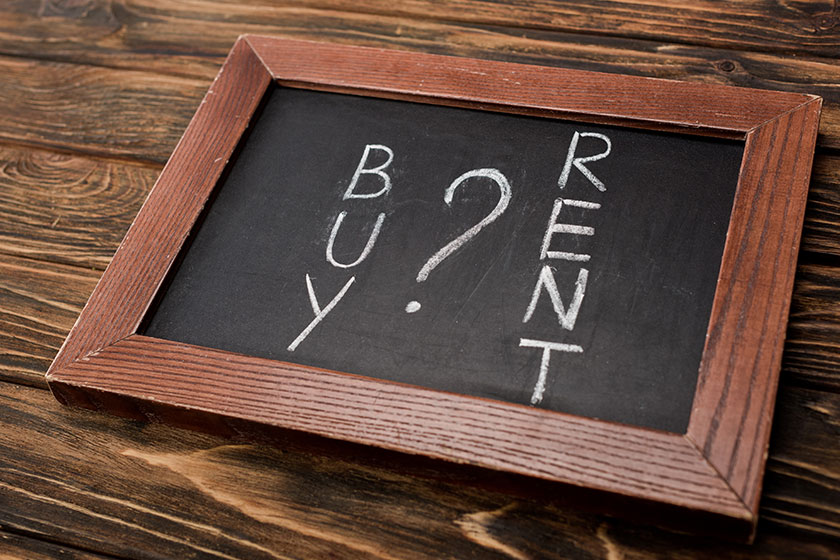 Chalkboard with buy and rent lettering on wooden surface