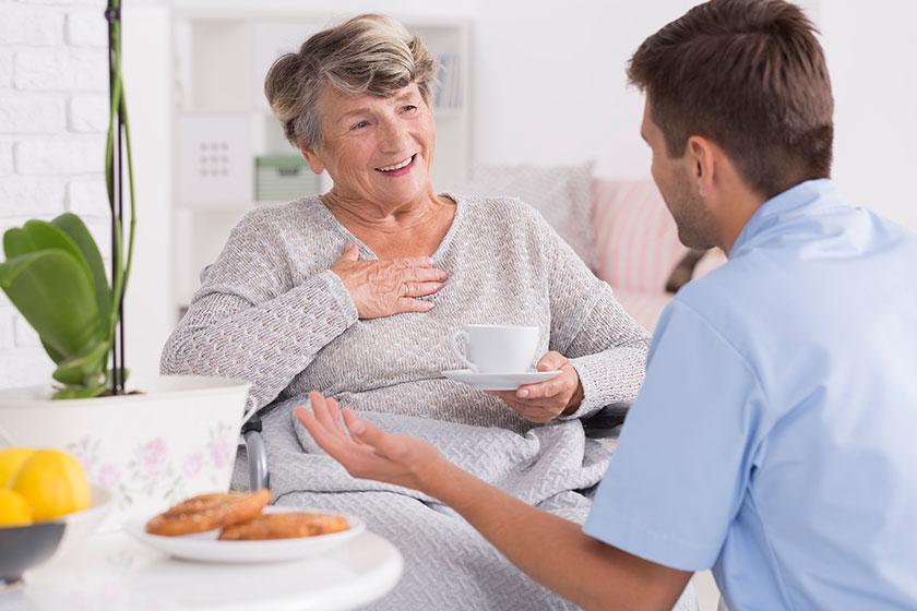 Smiled elder woman and her young male nurse Smiled elder woman and her young male nurse
