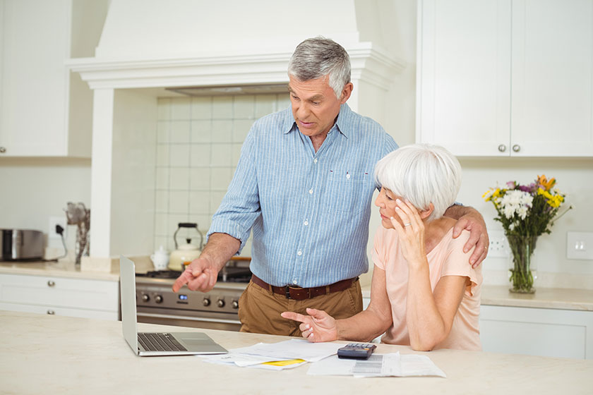 Senior man interacting with senior woman in kitchen