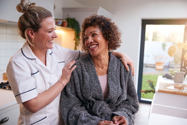 Mature Woman In Dressing Gown Talking With Female nurse Mature Woman In Dressing Gown Talking With Female nurse