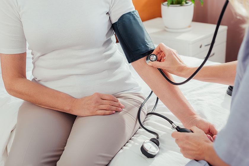 Nurse measuring blood pressure to patient Nurse measuring blood pressure to patient