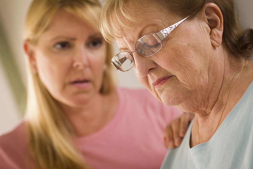 Young Woman Consoles Senior Adult Female Young Woman Consoles Senior Adult Female