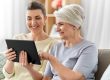 Daughter-and-senior-mother-with-tablet-pc-at-home