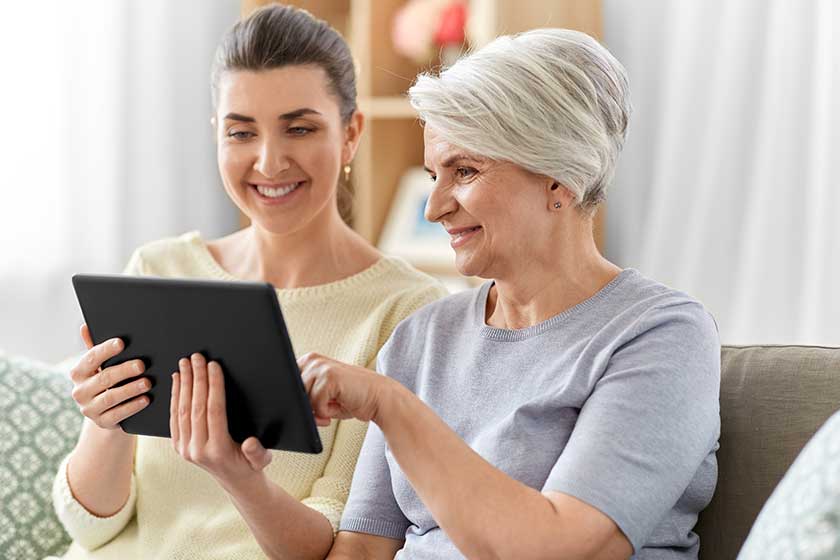 Daughter-and-senior-mother-with-tablet-pc-at-home