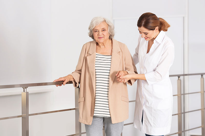 Elderly woman with female caregiver in bedroom. Elderly woman with female caregiver in bedroom.
