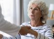 Hopeful old handicapped hoary woman holding hands