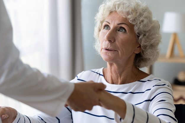 Hopeful old handicapped hoary woman holding hands Hopeful old handicapped hoary woman holding hands