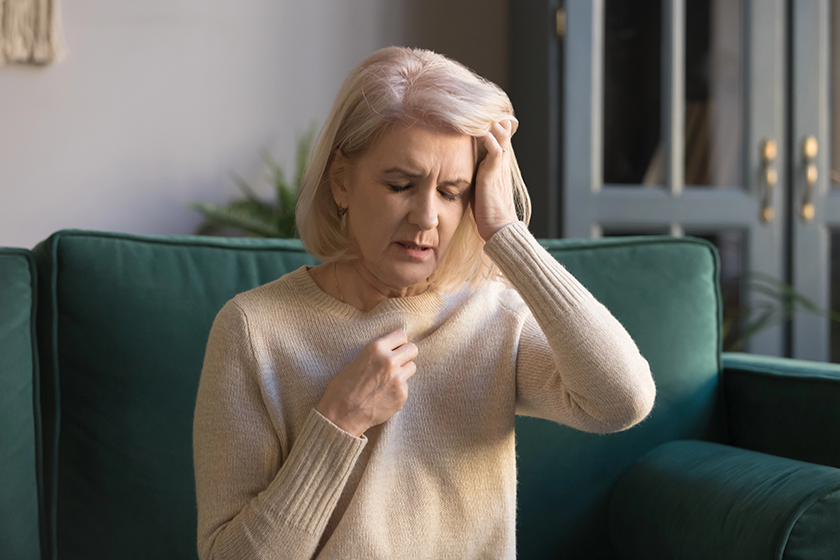 mature-woman-sit-on-couch-touches-head-feels-unhealthy mature-woman-sit-on-couch-touches-head-feels-unhealthy
