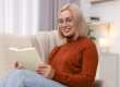 Portrait of smiling middle aged woman reading
