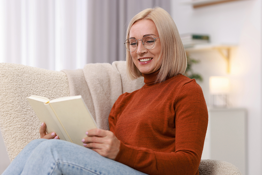 portrait-smiling-middle-aged-woman-reading-book Portrait of smiling middle aged woman reading