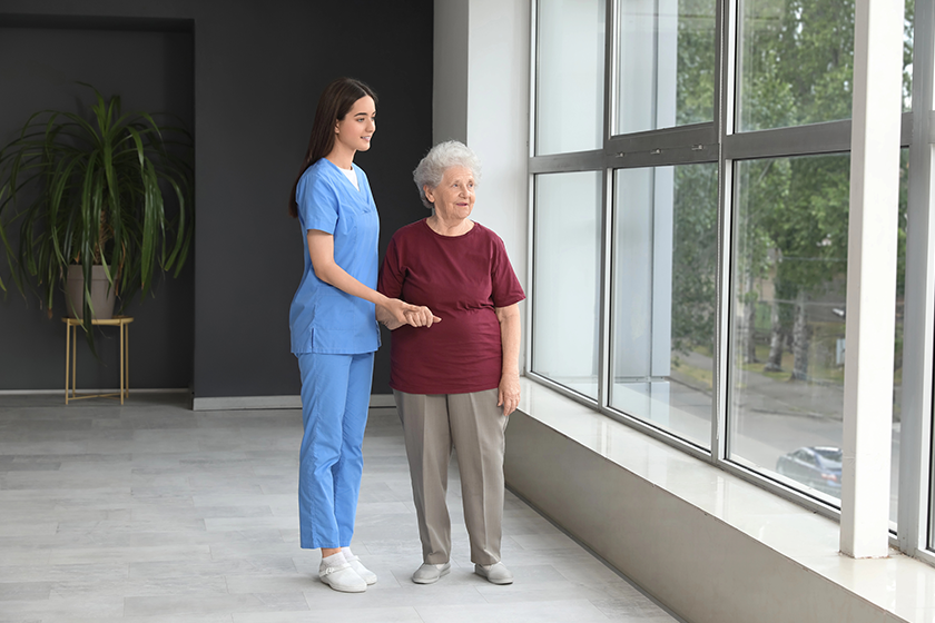 young-nurse-senior-woman-holding-hands Young nurse with senior woman holding hands