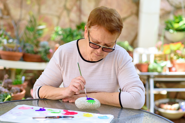 happy-authentic-senior-woman-sitting-outdoors Happy authentic senior woman sitting outdoors