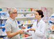 Pharmacist and senior man buying drug at pharmacy