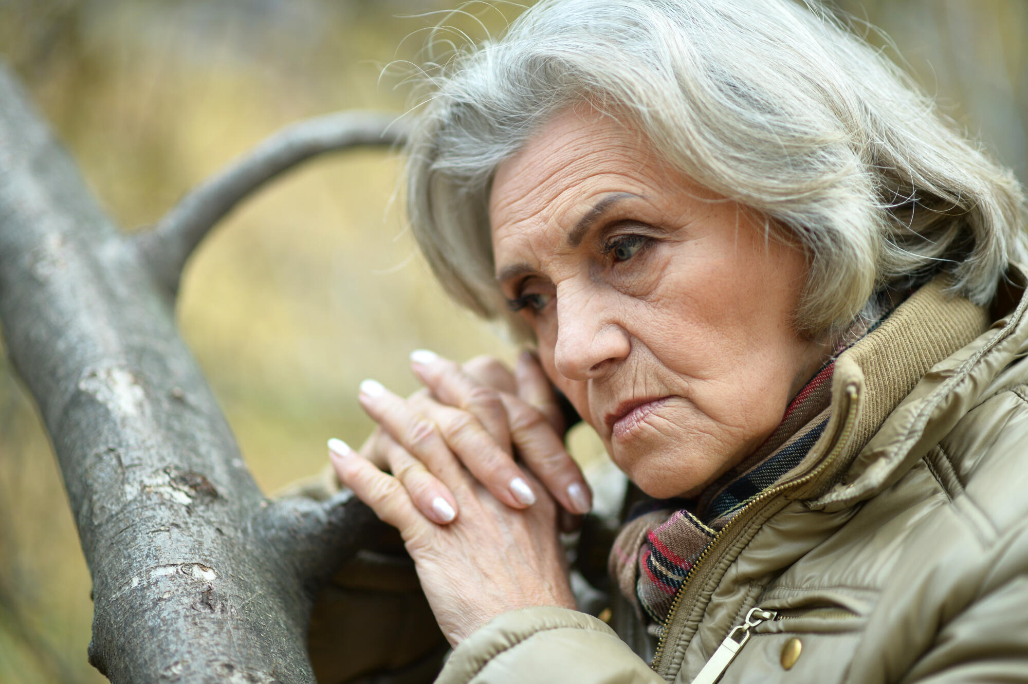 Portrait of senior sad woman in park
